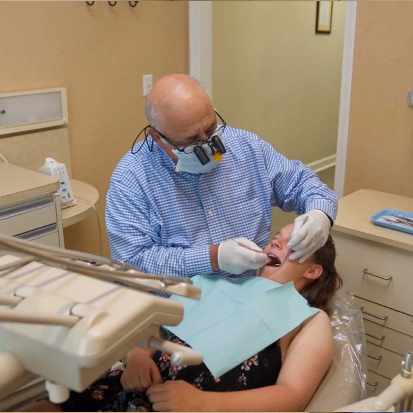 Dr. John R. Piccione working on the mouth of a patient sitting in a dental chair at Rocky Creek Dental Care